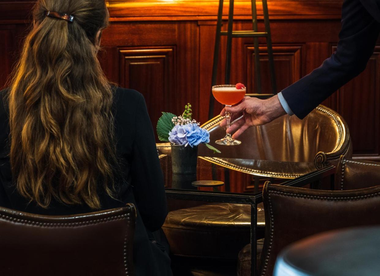 Hotel Pont Royal Paris Bagian luar foto A bartender serving a cocktail